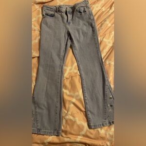 Bell bottom jeans with embroidered flowers on bottom legs.